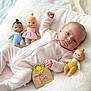 Maeve joined the competition — help win amazing prizes! baby, doll, soft_texture, onesie, milestone, wooden_sign, flower, pink, yellow, blue, pastel_colors, infant, lying_down, cute, toy, child, portrait, smiling, indoor, blanket