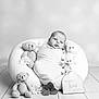 baby, infant, swaddled, teddy_bear, plush, pillow, flower, wooden_floor, black_and_white, portrait, cute, two_months, wrapped, soft_texture, flooring, child, newborn, decor, sitting, studio
