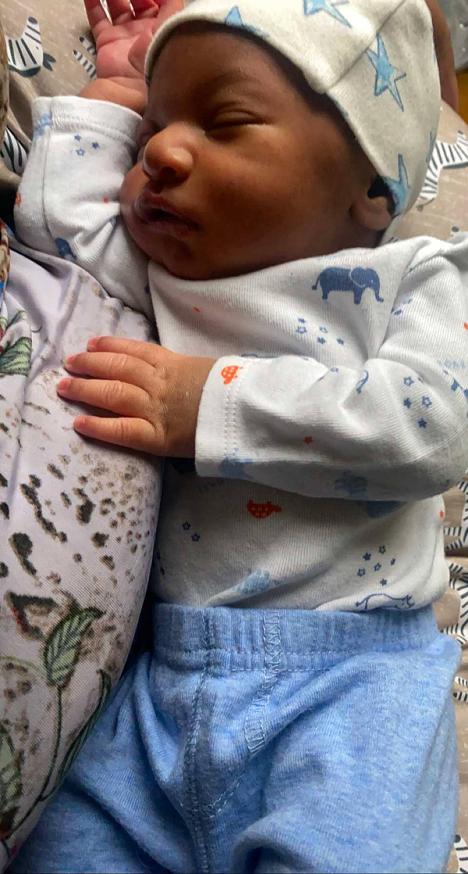 Antwan joined the competition — help win amazing prizes! baby, cap, child, clothing, facial_expression, finger, gesture, hand, human, joint, mammal, mouth, organ, outerwear, people, person, photograph, skin, sleeve, toddler