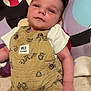 Rory joined the competition — help win amazing prizes! baby, infant, romper, clothing, face, person, mickey_mouse, pillow, cartoon_character, lying_down, cute, child, indoor, floor, pattern, animal_print, button, shorts, toddler, skin