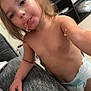 toddler, child, diaper, noodles, green_bowl, fork, eating, indoor, living_room, furniture, television, shelf, plastic_utensil, food, messy, cute, person, young_child, snack, casual