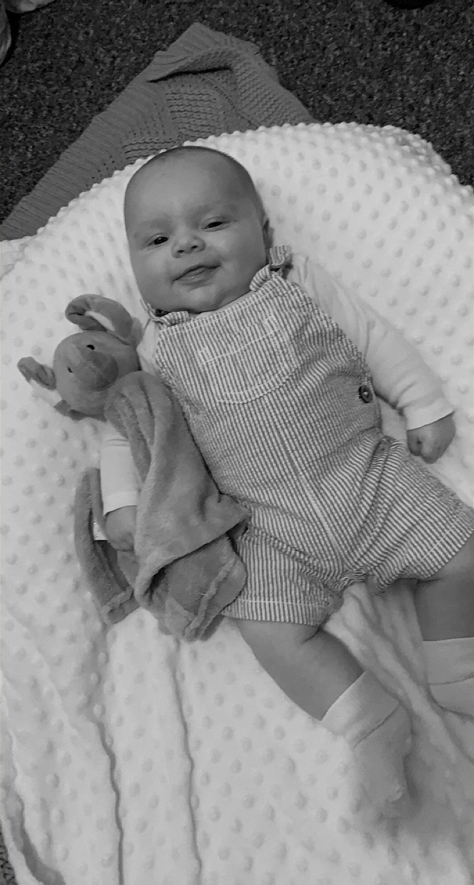 Hadlee-joe joined the competition — help win amazing prizes! arm, baby, baby_toddler_clothing, child, comfort, face, finger, head, linens, mammal, monochrome, monochrome_photography, person, photograph, product, skin, sleeve, smile, textile, toddler