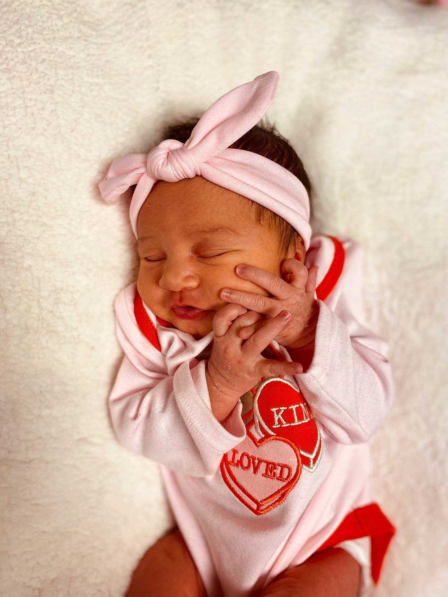 Denver is registered to the contest to win money with this photo: baby, baby_toddler_clothing, cheek, child, ear, eyelash, fashion_accessory, gesture, happy, laugh, linens, lip, magenta, nose, person, pink, sleeve, smile, t_shirt, thumb