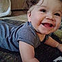 baby, child, smiling, curly_hair, striped_shirt, carpet, indoor, happy, face, tongue, crawling, infant, toddler, cute, skin, person, young_child, expression, cheerful, closeup