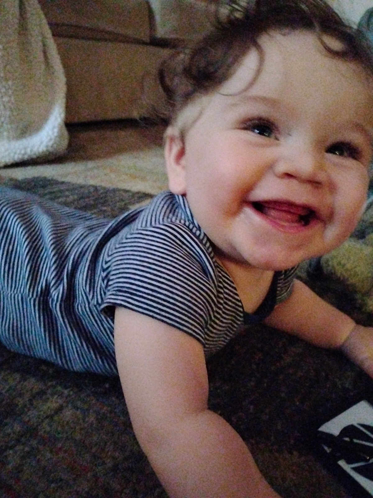 Ezekiel joined the competition — help win amazing prizes! baby, child, smiling, curly_hair, striped_shirt, carpet, indoor, happy, face, tongue, crawling, infant, toddler, cute, skin, person, young_child, expression, cheerful, closeup