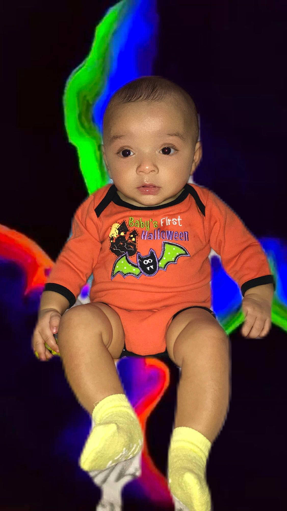 Kameron is registered to the contest to win money with this photo: arm, baby, baby_products, baby_toddler_clothing, cheek, child, electric_blue, finger, fun, happy, human_leg, magenta, person, pink, purple, shorts, sitting, sleeve, t_shirt, thigh