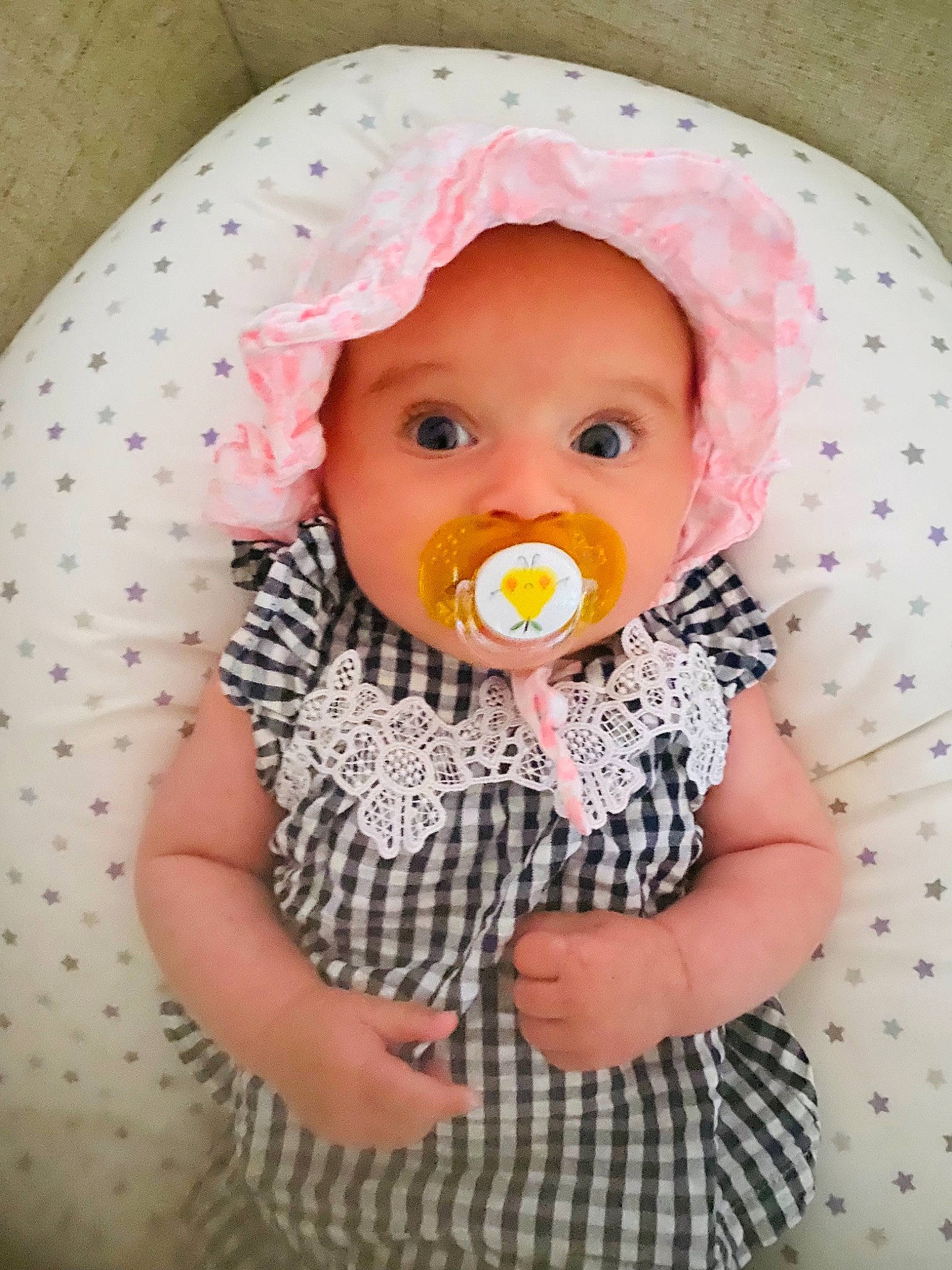 Lily participe au concours pour gagner de l'argent avec cette photo : baby, baby_products, baby_toddler_clothing, cheek, child, clothing, doll, dress, headgear, lip, mouth, nose, pattern, person, pink, skin, sleeve, stuffed_toy, sun_hat, toddler