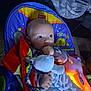 Mateo is registered to the contest to win money with this photo: baby, infant, toy, blanket, fisher_price, chair, hand, face, comfort, indoor, carpet, clothing, child, soft_toy, lighting, colorful, expression, person, cuddle, relax