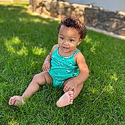Kehlani is registered to the contest to win money with this photo: toddler, child, grass, outdoor, sunlight, green, smiling, curly_hair, onesie, baby, happy, sitting, nature, daylight, skin, foot, portrait, casual, playful, young