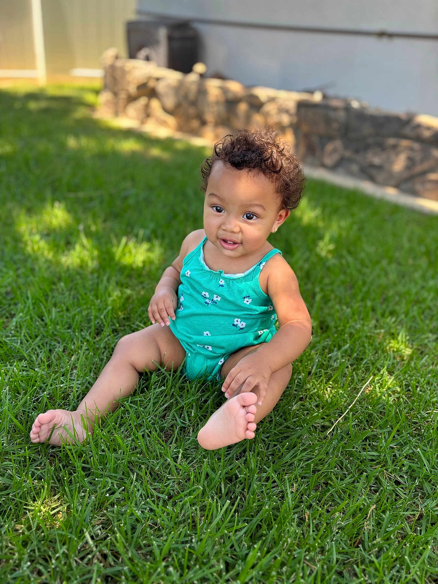 Kehlani is registered to the contest to win money with this photo: toddler, child, grass, outdoor, sunlight, green, smiling, curly_hair, onesie, baby, happy, sitting, nature, daylight, skin, foot, portrait, casual, playful, young