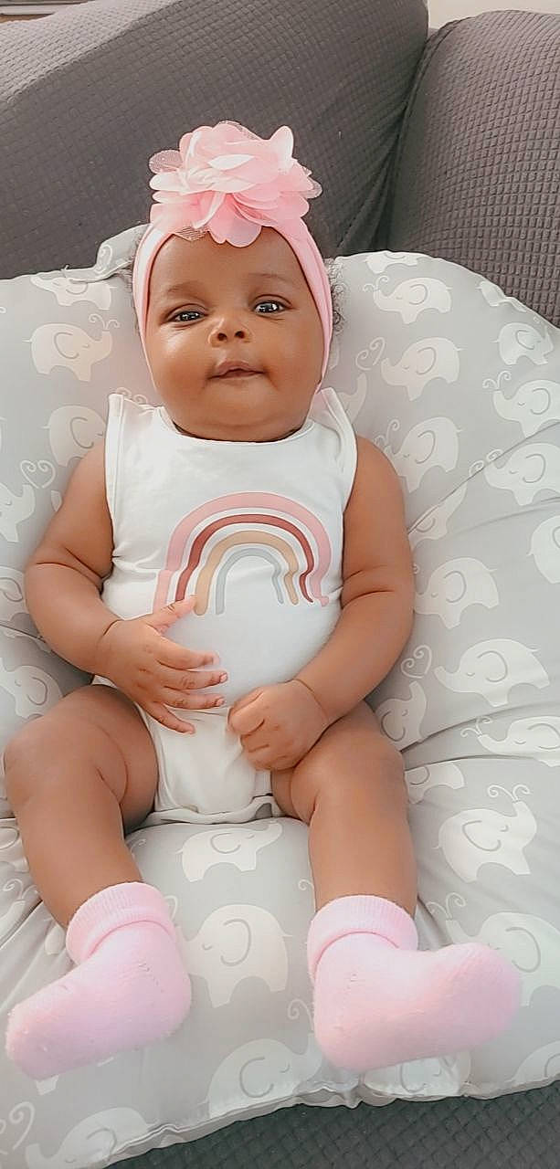Eri is registered to the contest to win money with this photo: baby, baby_toddler_clothing, cheek, chest, comfort, eye, face, gesture, happy, head, headwear, human_body, lip, person, pink, product, skin, stomach, thigh, thumb