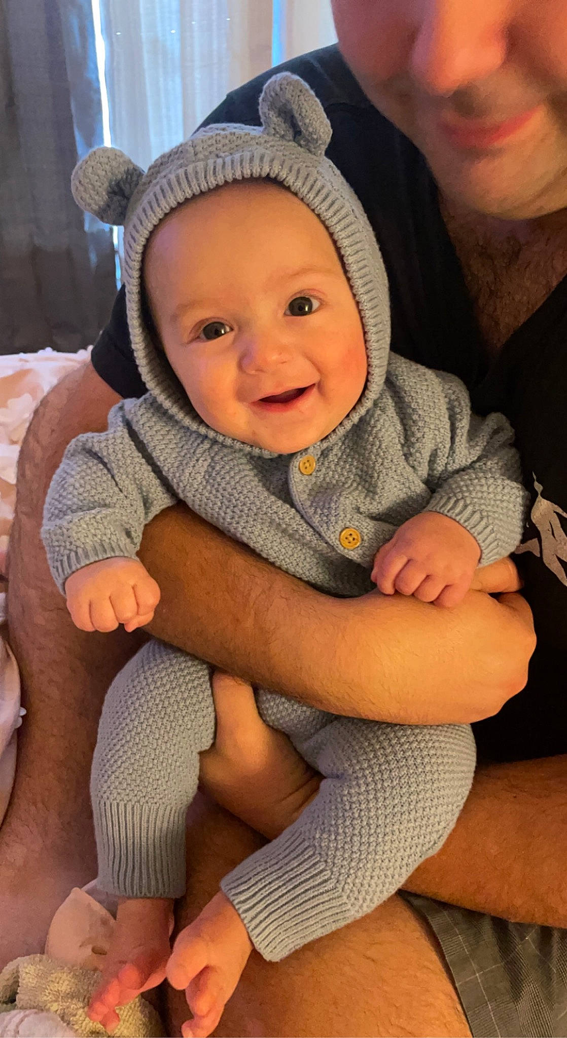 Everett is registered to the contest to win money with this photo: baby, baby_toddler_clothing, cheek, child, comfort, face, facial_expression, finger, happy, headgear, headwear, human, human_body, joy, lap, leg, mouth, person, skin, smile