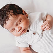 Ahzire is registered to the contest to win money with this photo: baby, sleeping, infant, white_clothing, ribbed_fabric, peaceful, closeup, cute, newborn, soft_light, portrait, child, hand, skin, face, hair, indoors, resting, calm, cozy