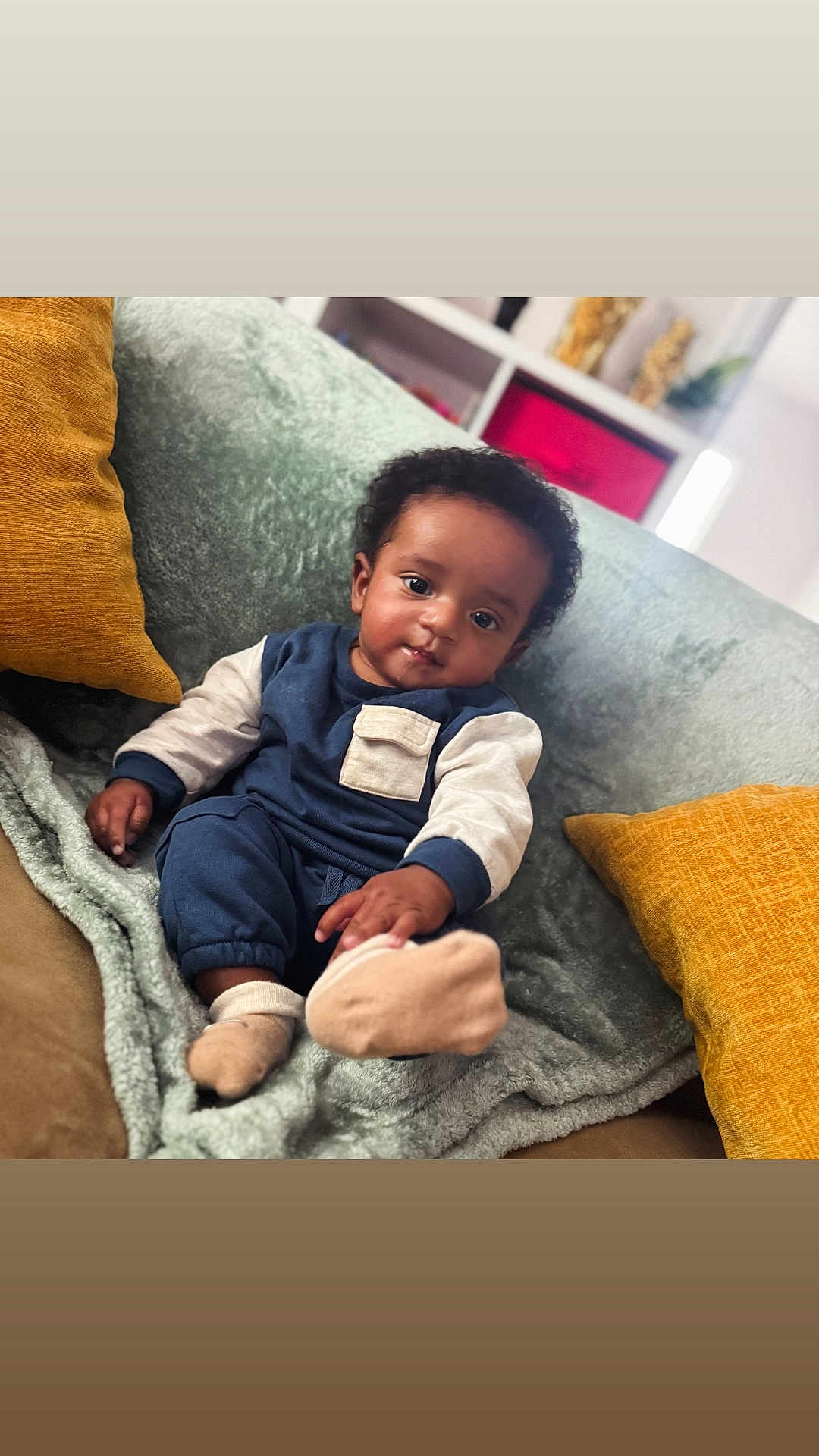 Noah joined the competition — help win amazing prizes! baby, child, infant, couch, pillows, blanket, socks, clothing, indoor, portrait, cute, smiling, relaxed, soft, comfortable, home, furniture, cozy, person, seated