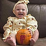 baby, infant, pumpkin, smiling, cute, headband, autumn, fall, holiday, orange, clothing, sitting, couch, foot, hand, face, happy, child, portrait, home
