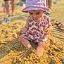 beach, blurred_background, child, exploration, footwear, fun, hands, legs, nature, outdoor, people, pink, play, romper, sand, summer, sunhat, sunlight, toddler, vacation