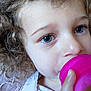 baby, blue_eyes, child, close_up, clothing, curly_hair, cute, drinking, expression, face, hand, hydration, indoor, innocent, person, pink_cup, portrait, skin, toddler, young