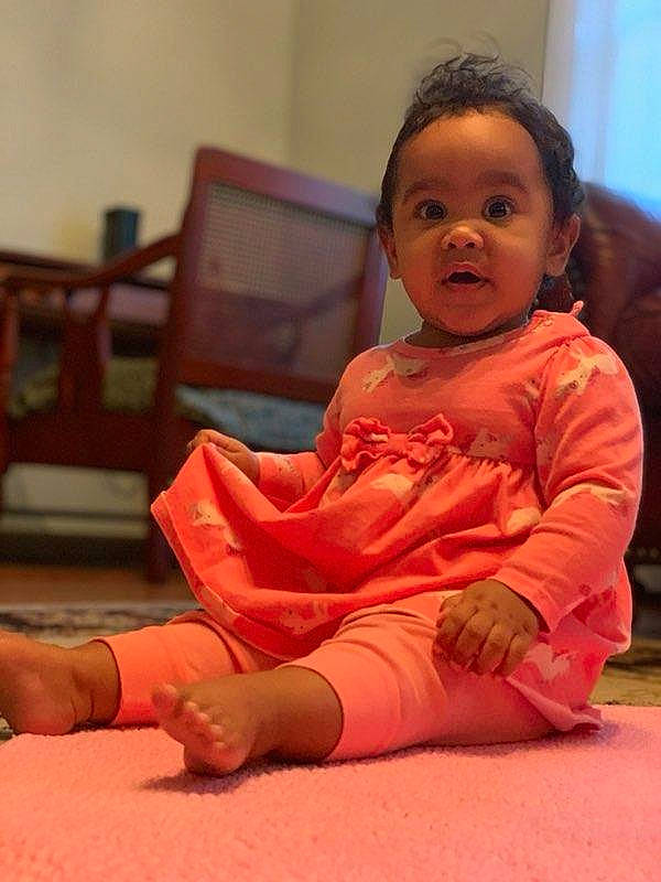 Arianna joined the competition — help win amazing prizes! baby_toddler_clothing, child, comfort, elbow, eye, face, floor, flooring, foot, fun, happy, hardwood, head, human_leg, knee, person, skin, sleeve, thigh, toddler