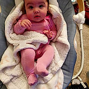 Grace joined the competition — help win amazing prizes! baby, blanket, pink_pajamas, infant, face, cushion, baby_seat, carpet, home_interior, floor, toy, keyboard, striped_clothing, child, soft_texture, relaxed, cute, indoor, person, warm