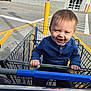 Kaison joined the competition — help win amazing prizes! adult_arm, blue_sweater, casual_clothing, child, cute, daylight, grip, hand, happy, metal, outdoor, parking_lot, person, playful, retail, shopping_cart, smiling, store_exterior, toddler, yellow_lines
