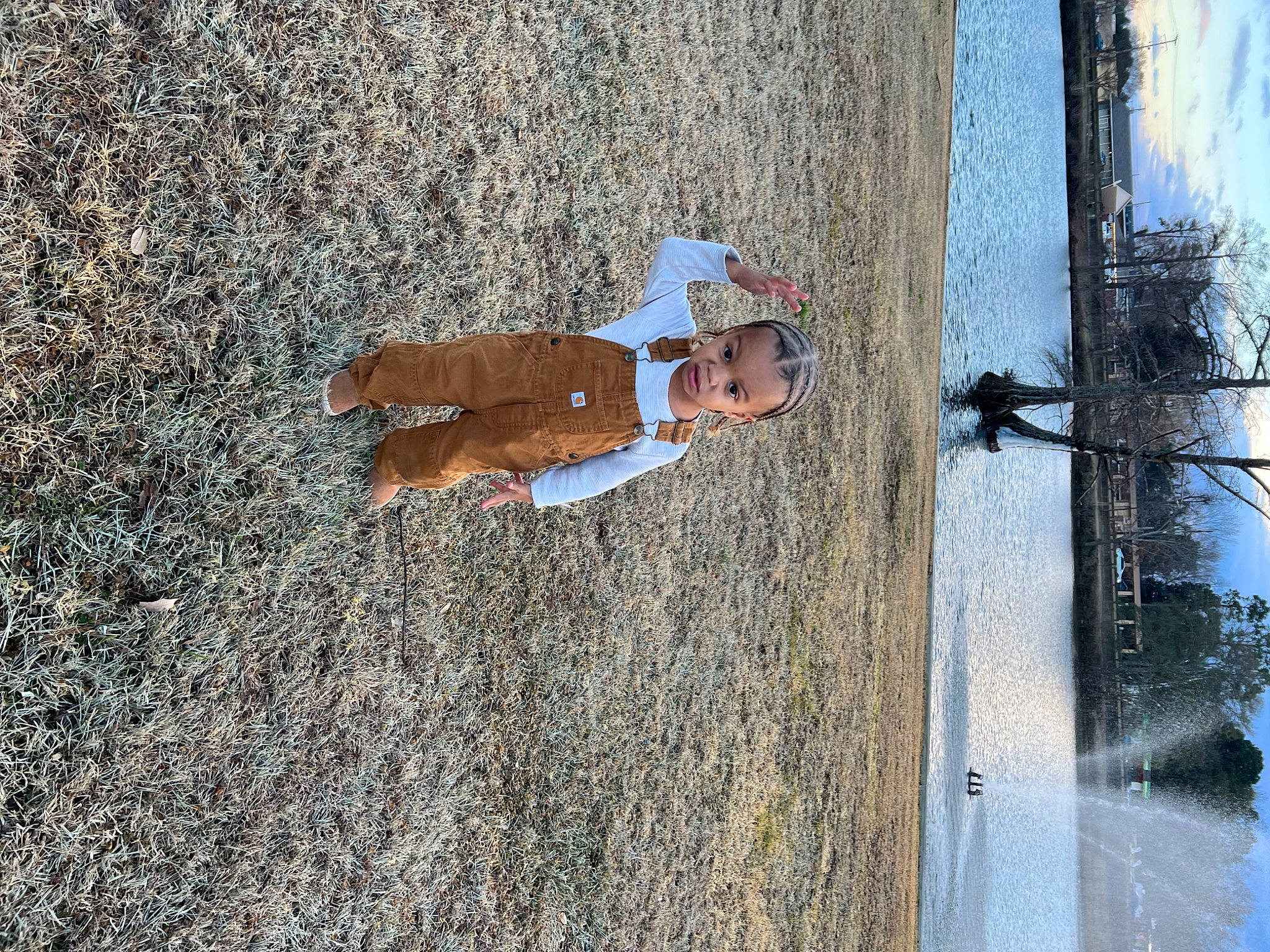 Kyrin is registered to the contest to win money with this photo: asphalt, concrete, elbow, fun, hat, lake, landscape, leisure, person, plant, recreation, reflection, road_surface, shadow, sidewalk, sky, soil, toddler, tree, water