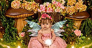 Patsy is registered to the contest to win money with this photo: child, fairy_wings, pink_dress, flower_crown, mushrooms, flowers, glowing_orb, magical_forest, fantasy, nature, greenery, sparkles, portrait, young_girl, costume, fantasy_theme, enchanted, sitting, cute, whimsical