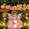 child, fairy_wings, pink_dress, flower_crown, mushrooms, flowers, glowing_orb, magical_forest, fantasy, nature, greenery, sparkles, portrait, young_girl, costume, fantasy_theme, enchanted, sitting, cute, whimsical