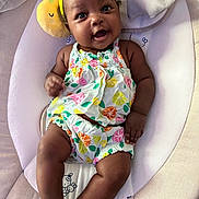 Phoenix joined the competition — help win amazing prizes! baby, infant, smiling, yellow_headband, colorful_clothing, baby_rocker, cushion, cute, happy, indoors, child, portrait, playful, resting, young_child, expressive_face, headwear, bright_colors, comfortable, adorable