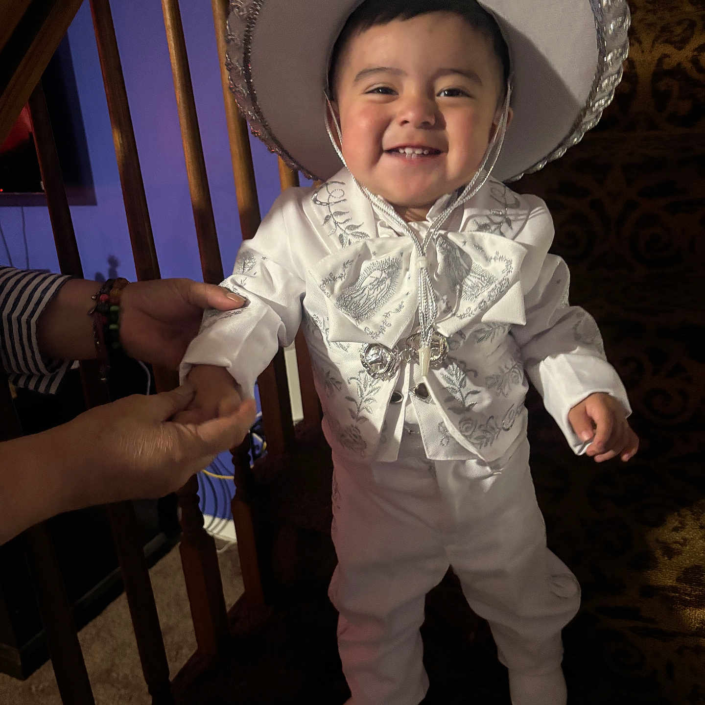 Leo joined the competition — help win amazing prizes! child, toddler, smiling, portrait, cowboy_hat, white_outfit, costume, festive, indoor, wooden_chair, carpet, home, adult_hands, standing, happy, face, fashion, sparkly, celebration, photography