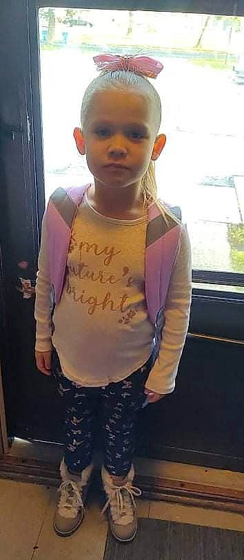 Naomi is registered to the contest to win money with this photo: baby_toddler_clothing, belt, child, cool, facial_expression, family_car, finger, fun, gesture, handwriting, happy, person, personal_protective_equipment, skin, sleeve, standing, t_shirt, thumb, toddler, trunk