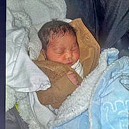 Je'Saiah joined the competition — help win amazing prizes! newborn, baby, sleeping, blanket, brown_jacket, cozy, infant, soft, wrapped, cute, warm, resting, indoors, child, face, peaceful, portrait, baby_clothing, head, tiny_hand
