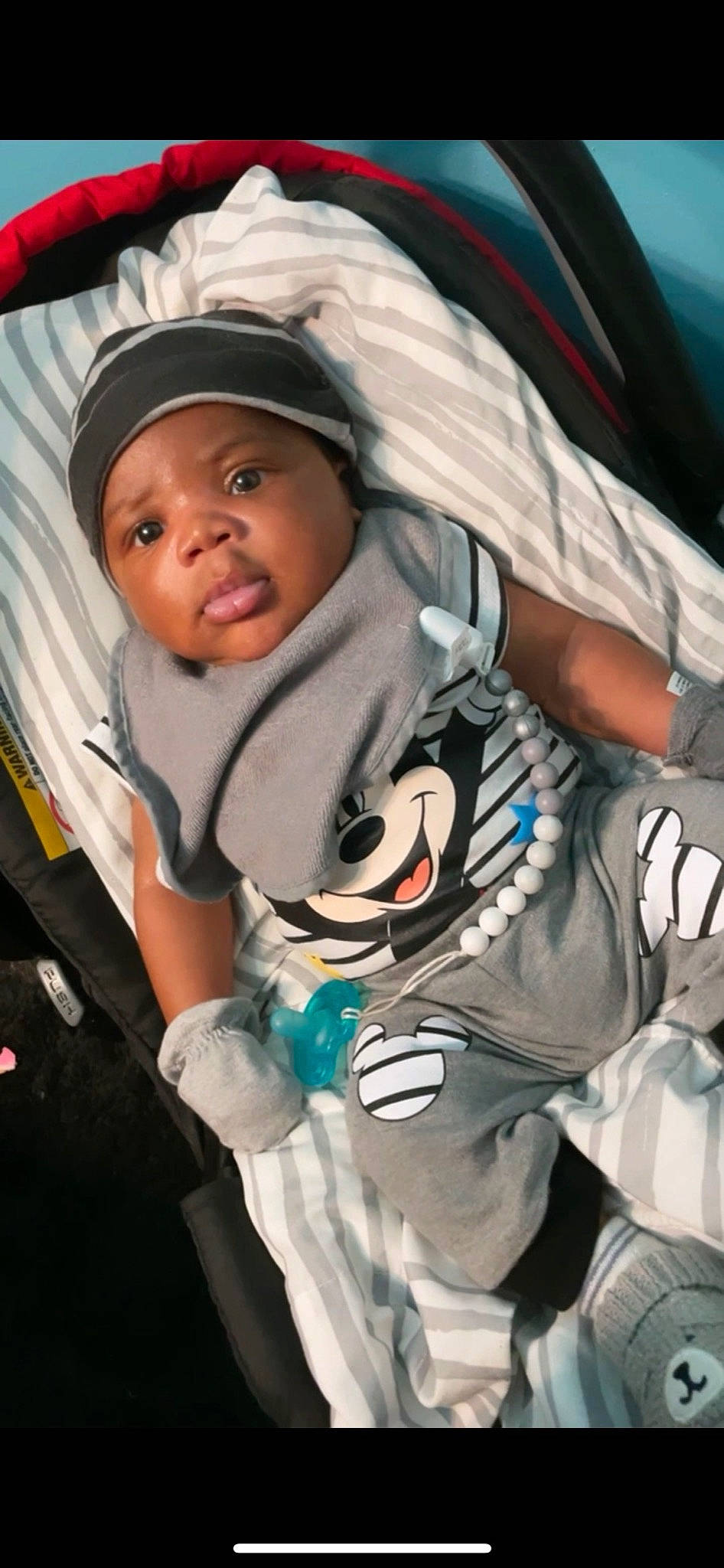 Kartier is registered to the contest to win money with this photo: baby, baby_carriage, baby_products, baby_toddler_clothing, cap, child, comfort, electric_blue, flash_photography, fun, gesture, happy, headwear, hoodie, person, product, sitting, sleeve, smile, snapshot