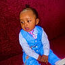 Amir is registered to the contest to win money with this photo: baby, blue_suit, child, curious_expression, cute, earrings, fashion, formal_clothing, hair_bun, indoors, pacifier, pink_tie, portrait, red_couch, sitting, small_hands, striped_shirt, toddler, white_shoes, young_child