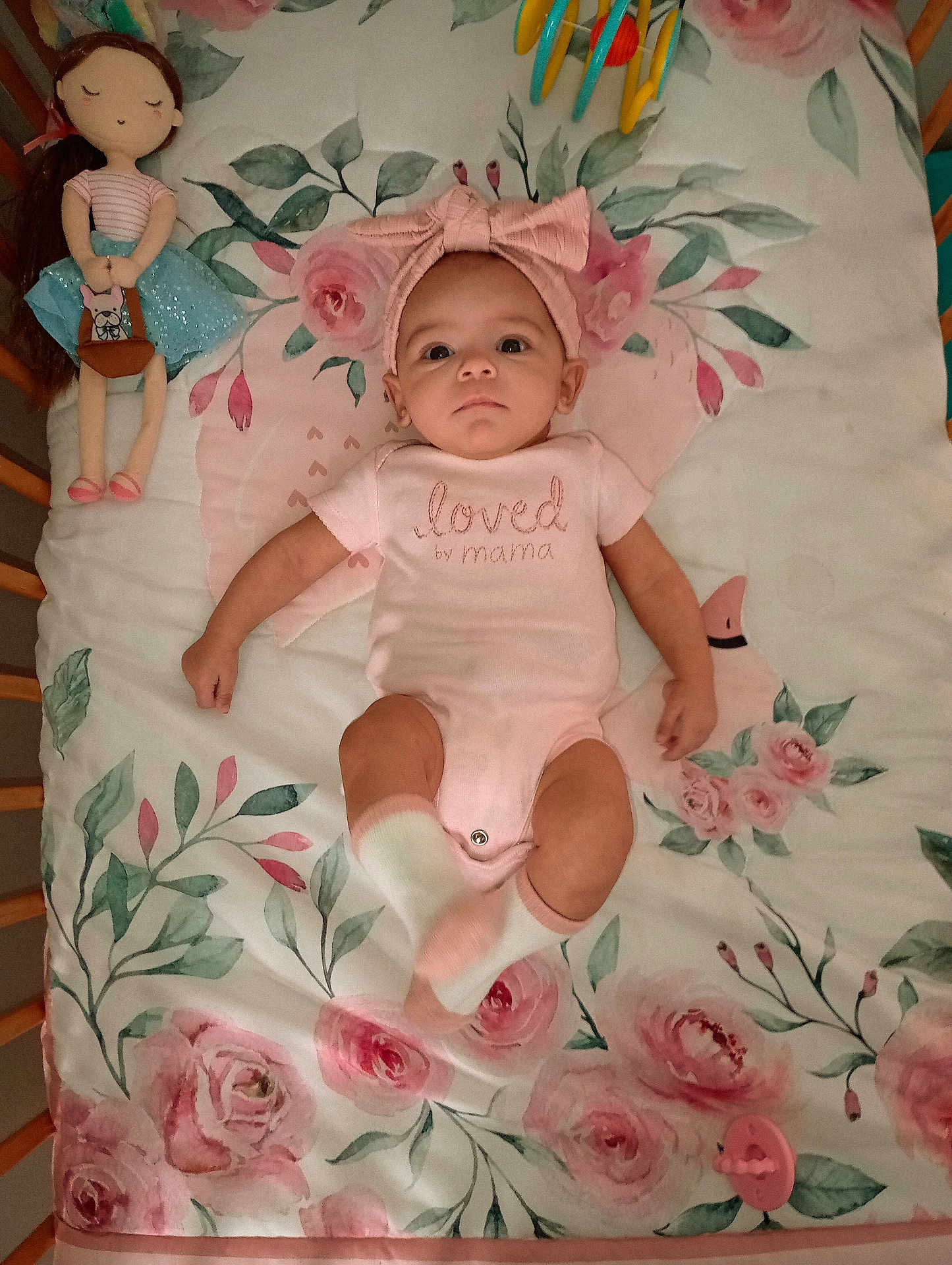 Amarah Love Saunders joined the competition — help win amazing prizes! baby, blanket, child, crib, cute, decor, doll, floral_pattern, headband, infant, lying_down, nursery, pacifier, person, pink_clothing, sleeping_area, socks, soft_toys, toddler, toy