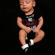 Amarah Love Saunders is registered to the contest to win money with this photo: baby, sleeping, black_onesie, headband, flower, nike_socks, infant, peaceful, portrait, child, closed_eyes, resting, cute, adorable, young_child, black_background, soft_lighting, hands, feet, clothing