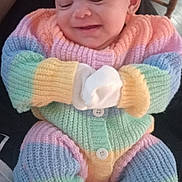 Amarah Love Saunders joined the competition — help win amazing prizes! baby, infant, knitwear, pastel_colors, smiling, mittens, person, indoor, seated, cozy, cute, child, hands, legs, clothing, warm, buttoned, portrait, happy, resting