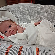 Amarah Love Saunders joined the competition — help win amazing prizes! adorable, baby, child, comfort, cushion, cute, face, flower, hand, headband, indoor, infant, lying_down, newborn, panda_slippers, patterned_fabric, resting, smile, soft_fabric, white_clothing