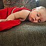 baby, blanket, child, comfort, couch, cozy, face, furniture, home, indoor, infant, peaceful, portrait, red_blanket, relaxation, rest, skin, sleeping, soft_light, young_child