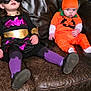 child, costume, superhero, pumpkin, orange, purple, black, mask, couch, leather, indoor, floor, sock, sitting, cute, baby, toddler, bookshelf, decoration, wood_floor