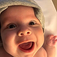 Charlie Anderson joined the competition — help win amazing prizes! baby, face, smile, happy, wide_eyes, hat, infant, skin, mouth, hand, joy, cute, closeup, child, expression, person, newborn, headwear, cheerful, indoors