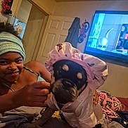 Hercules joined the competition — help win amazing prizes! bed, bedroom, blanket, bonnet, brown_skin, child, cute, dog, door, furniture, hand, headband, home, indoor, pajamas, pet_clothing, playful, smiling, television, wall_decor
