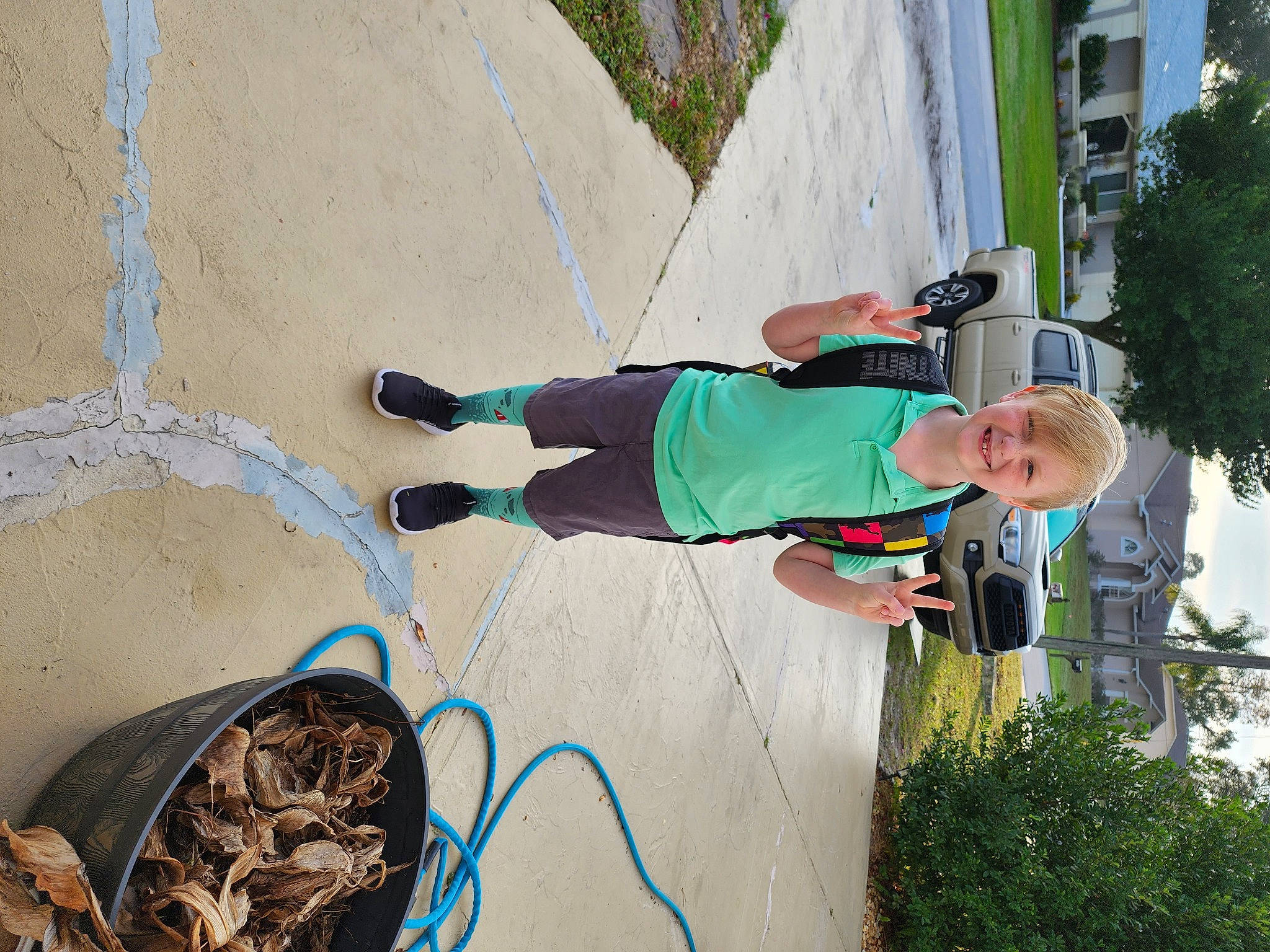 Zander is registered to the contest to win money with this photo: automotive_tire, bicycle_tire, concrete, electrical_supply, electrical_wiring, fun, grass, hose, joy, leisure, person, plant, recreation, rope, sidewalk, soil, tree, walking_shoe, wire
