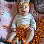 baby, candy_corn, blanket, yawning, headband, pumpkin, ghost, shoes, orange, white, black, halloween, costume, infant, cute, festive, lying_down, soft_toy, decor, celebration