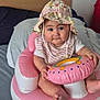 baby, infant, hat, pink, inflatable, toy, bed, pillow, child, face, cute, sitting, indoor, clothing, person, play, colorful, smile, comfort, young