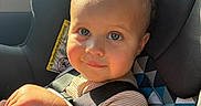 Leo joined the competition — help win amazing prizes! automobile, baby, blue_eyes, car_seat, child, close_up, curly_hair, face, indoor, infant, passenger, portrait, safety_harness, sitting, smiling, striped_clothing, sunlight, toy, travel, vehicle