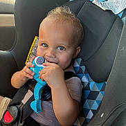 Leo is registered to the contest to win money with this photo: baby, blue_toy, buckled, car_interior, car_seat, child, curious, eyes, face, hands, infant, patterned_fabric, portrait, safety_harness, short_hair, smiling, striped_shirt, sunlight, toy, vehicle