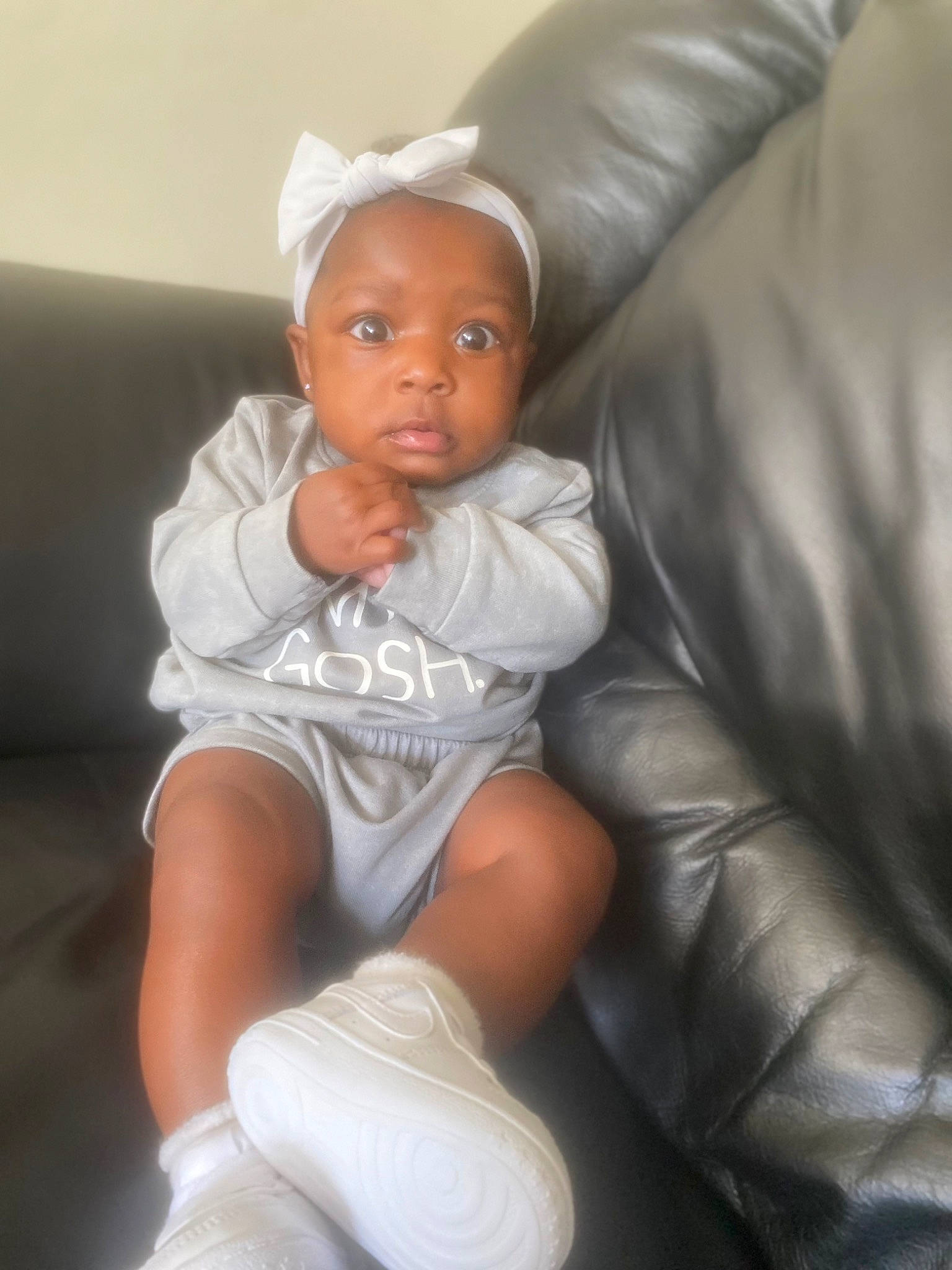 Emani joined the competition — help win amazing prizes! arm, baby, baby_toddler_clothing, blond, child, comfort, couch, eyebrow, face, finger, flash_photography, fun, human_leg, knee, lip, mouth, person, sitting, textile, thigh