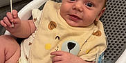 Nikolas joined the competition — help win amazing prizes! baby, baby_seat, bib, carpet, child, clothing, cotton_swab, cute, expression, face, floor, human, indoor, infant, pacifier, skin, small, smile, toy, young