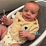baby, baby_seat, bib, carpet, child, clothing, cotton_swab, cute, expression, face, floor, human, indoor, infant, pacifier, skin, small, smile, toy, young