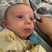 Nikolas joined the competition — help win amazing prizes! baby, bear_print, bed, blanket, blue_eyes, child, closeup, comfort, cute, face, hand, indoors, infant, newborn, onesie, pacifier, portrait, resting, sleepwear, soft_toys